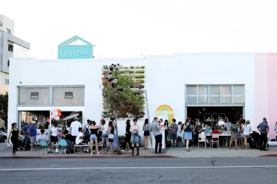 A group of people congregates on a sunny day outside of the Pigment store in San Diego's North Park neighborhood.