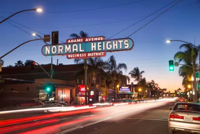 Normal Heights neighborhood sign over Adams Avenue during a sunset in San Diego