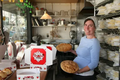 A baker holds pies amid stacked boxes inside Mom's Pie Shop in beautiful Julian, in the mountains near San Diego.