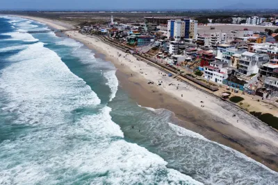 Aerial of a beach in Tijuana Mexico near the border with San Diego in the background