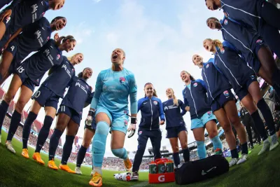 The San Diego Wave players in a group together before the game starts on the field at Snapdragon Stadium