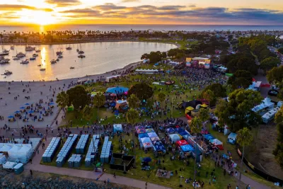 An aerial shot of Mission Bay during Bayfest as the sun is setting over the Pacific in San Diego