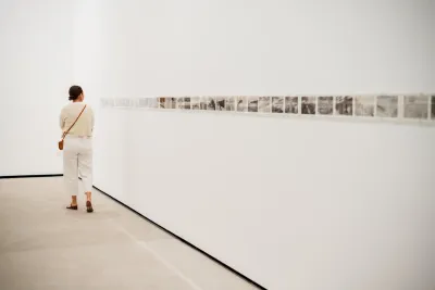 A woman looking at piece of art in an art museum located in San Diego