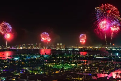 Fireworks going off at the same time across the San Diego Bay on the Fourth of July