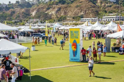 People walking around the Del Mar Wine and Food Festival during the grand tasting in San Diego