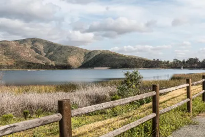 A view of Otay Lakes in Chula Vista near San Diego, bordered by hills and green vegetation.