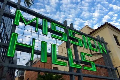 A sign in green letters reads "Mission Hills" in the Uptown neighborhood of San Diego.