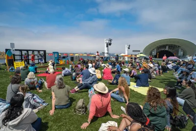 Free Event in San Diego at the Rady Shell a large group of people sitting on the lawn of the Rady Shell