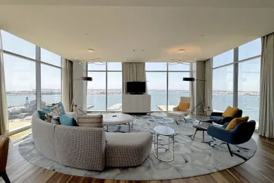 Bright and modern lounge with large windows overlooking a waterfront view.