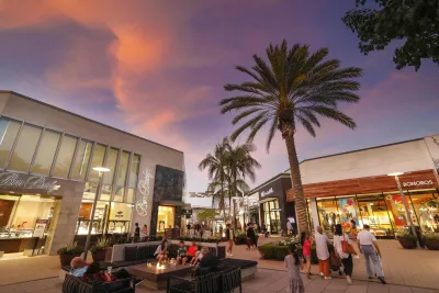 Outdoor shopping area at sunset, featuring palm trees and people mingling at the Westfield UTC Mall in San Diego.