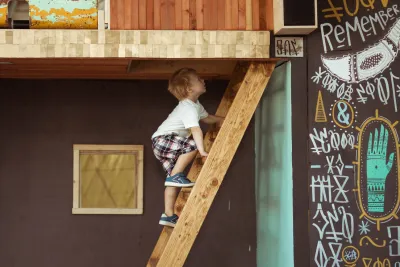 Young boy climbing up stairs inside of museum