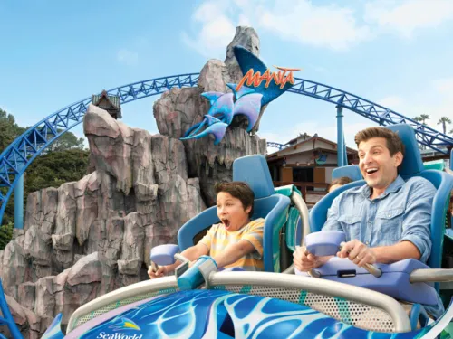 Father and son excited riding the Manta rollercoaster at SeaWorld San Diego