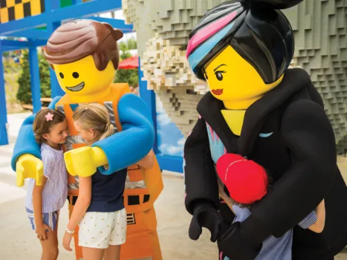 Kids hug LEGOLAND® California characters at the San Diego, CA amusement park