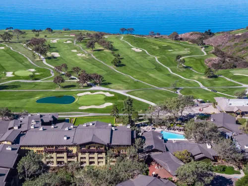 Aerial shot of the Lodge at Torrey Pines Resort with the Torrey Pines Golf Course stretching out toward the Pacific Ocean