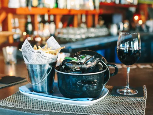 Oyster dish with a glass of red wine at Bleu Boheme in Kensington