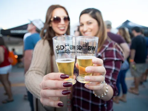 Two women cheersing their beers during San Diego Beer Week