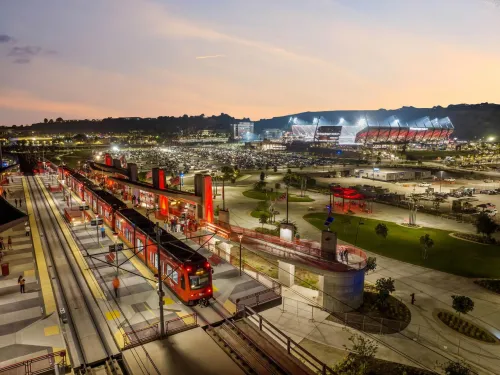Trolley is stopped outside of Snapdragon Stadium at dusk in San Diego, CA