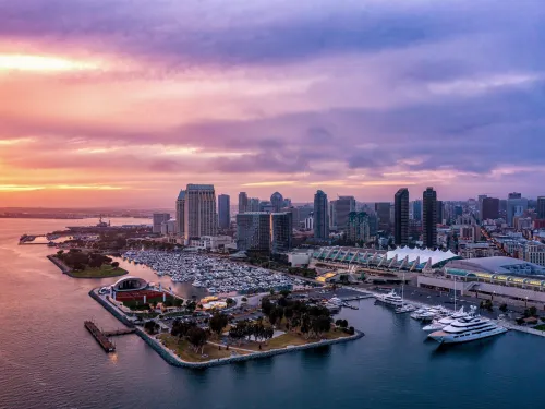 Sunset view of downtown San Diego with the Rady Shell at Jacobs Park, San Diego Convention Center and skyscrapers