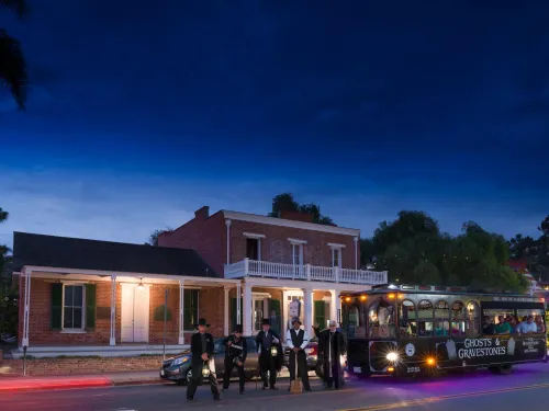The outside street view of Whaley House at dusk with clear skies. 