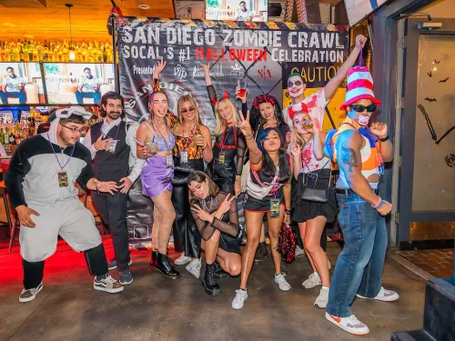 A group of people in Halloween costumes in the middle of their zombie crawl in Gaslamp in downtown San Diego