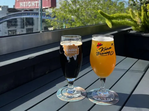 Two drinks on a table overlooking Kairoa Brewing Co.'s rooftop in University Heights