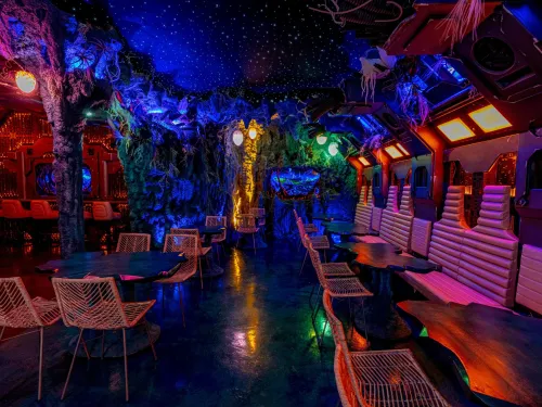 A colorful space-themed inside of a restaurant named Mothership in South Park