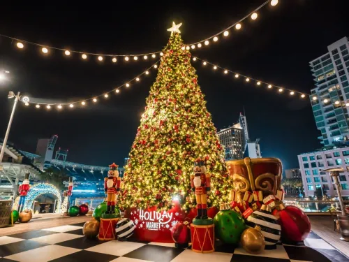 A decorated and lighted Christmas tree is depicted at night in beautiful San Diego as part of Petco Park's Holiday Wonderland event.
