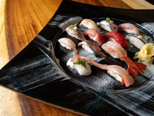 Multiple pieces of omakase on a black plate at SOICHI Sushi 