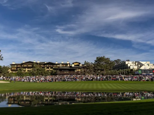 Crowd of spectators overlooking the 18th hole with the Lodge at Torrey Pines and the Hilton La Jolla Torrey Pines in the background