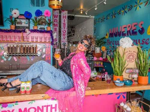 Owner of Mujertas Brew House in Barrio Logan in San Diego on the bar at her brew house