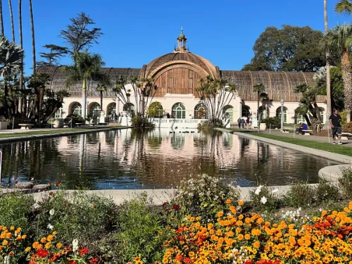 The Botanical Building at Balboa Park with flowers and a koi pond in front
