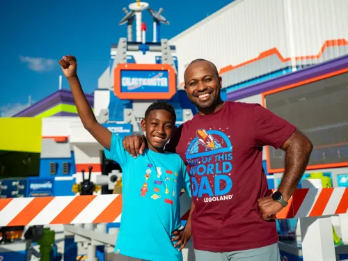 A man and a boy smile and pose together at LEGOLAND California in Carlsbad near San Diego.