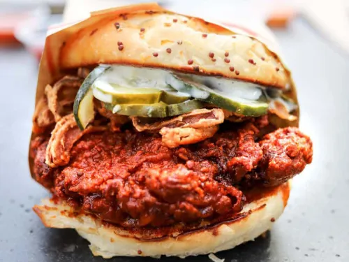 Crack Shack loaded chicken sandwich with pickles, sauce, on a bun in San Diego, CA