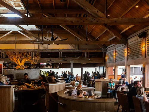 People dining indoors of Jake's Del Mar along the beach in San Diego, CA