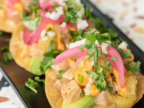 Fish tacos topped with cilantro at Lola 55