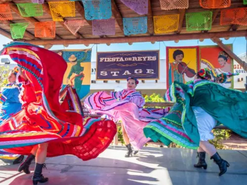 Colorful folklórico dancers on stage at Fiesta de Reyes in Old Town San Diego, CA