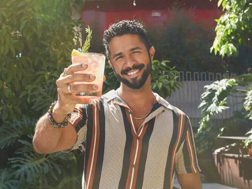 Gabriel Feitosa cheersing a cockail in Hillcrest, San Diego, CA