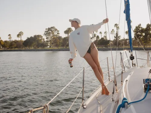 Woman stands aboard the Seaforth Yacht Charters looking off towards the water