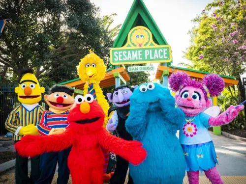 Seven Sesame Street characters standing at the entrance of Sesame Place in San Diego, CA