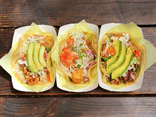 3 fish tacos laying on a table in San Diego, CA