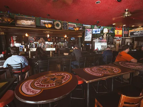 Tivoli Bar and Grill in Gaslamp Quarter with people sitting at tables in this San Diego dive bar