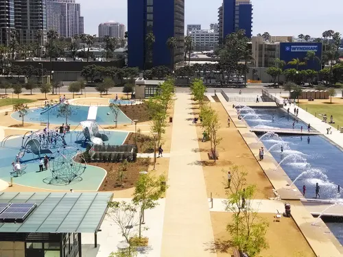 Aerial of Waterfront Park in Downtown San Diego with jungle gyms, fountains, and grass