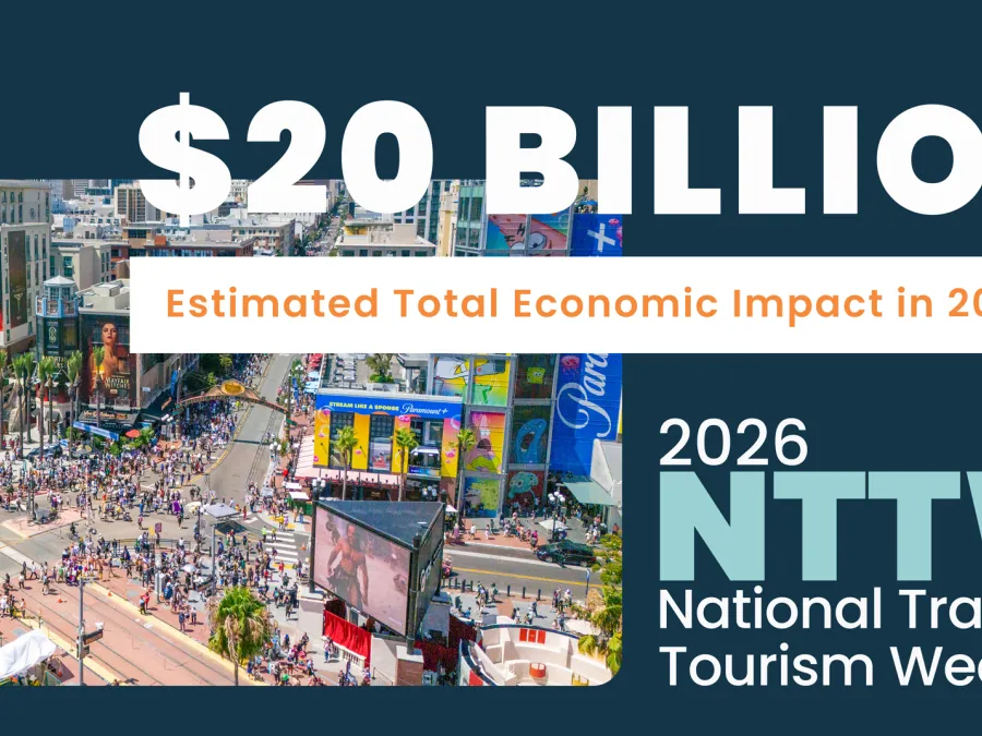 Crowd in a busy area with colorful signage, promoting $20 billion economic impact for 2026 tourism.