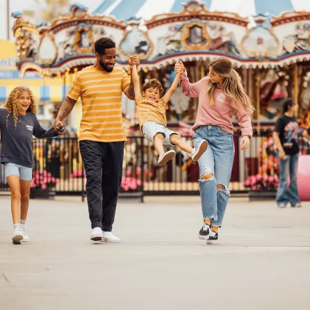 Family of four with two kids walking into Belmont Park